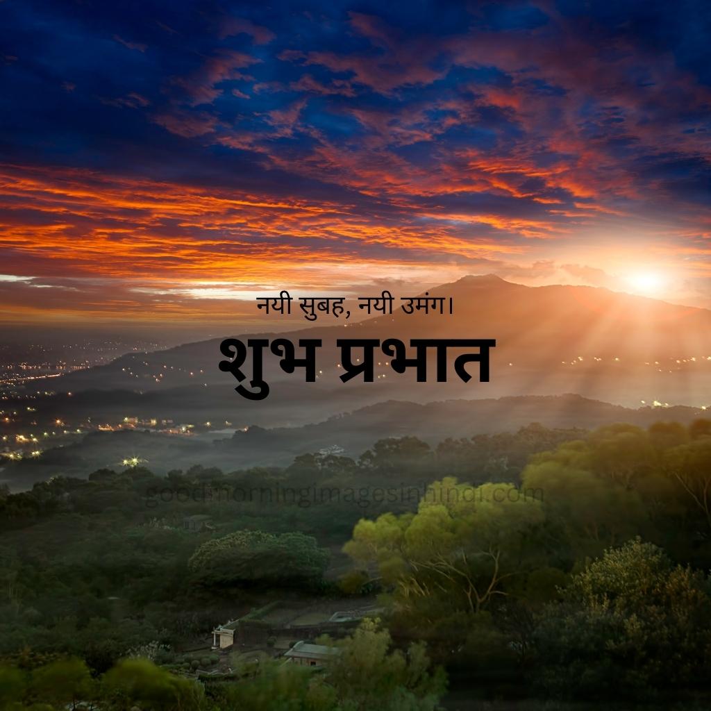 Shubh Prabhat! A perfect circle of yellow sun sits proudly in a clear blue sky, dwarfing the silhouette of a majestic mountain range good morning images in hindi