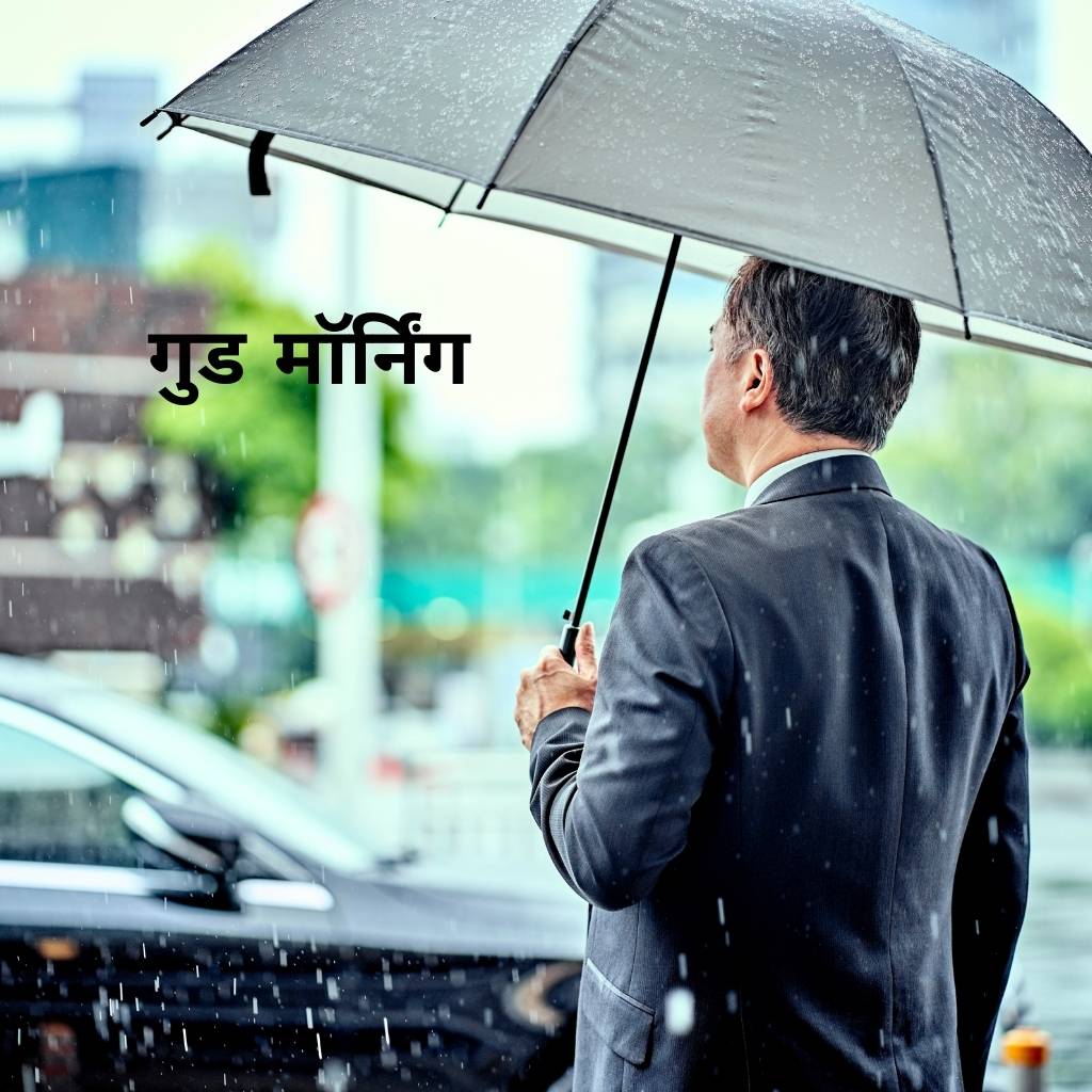 a businessman holding umbrella in the rain